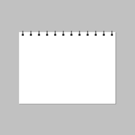 The notebook page is open on a white background. An empty spiral notebookの写真素材