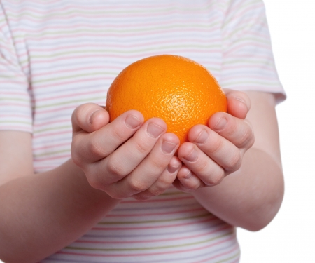 Orange in palms of the childの写真素材