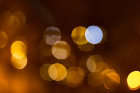 Orange bokeh of city lights on darck orange background.