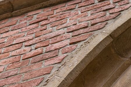 Concrete arch on a Brick Wall. Historical Architecture