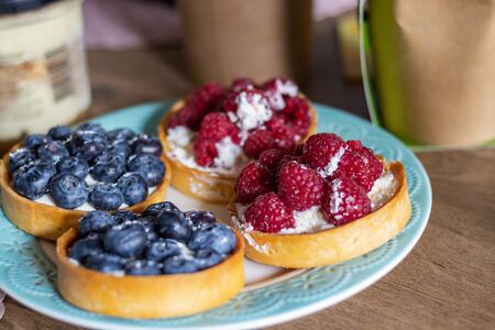 Delicious Tartlets from shortcrust pastry with Blueberries and Raspberries. Healthy pastries
