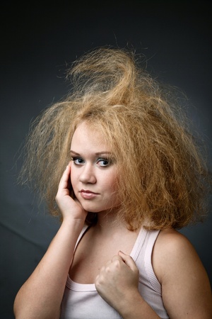 An image of funny unkempt woman. Portrait on dark backgroundの写真素材