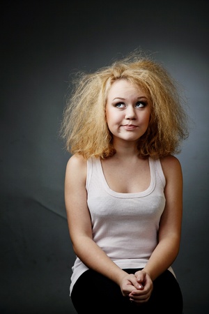 An image of funny unkempt woman. Portrait on dark backgroundの写真素材