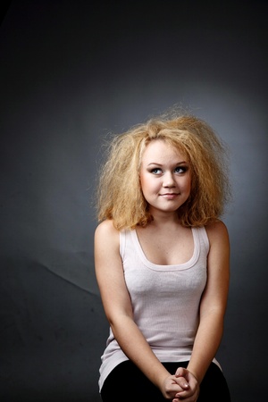 An image of unkempt woman. Portrait on dark backgroundの写真素材