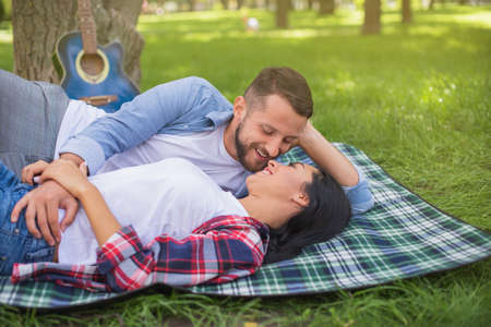 Love sight and perfect relationship. Guy is holding girlfriends hand. Romantic date with guitar. Romantic first dateの写真素材