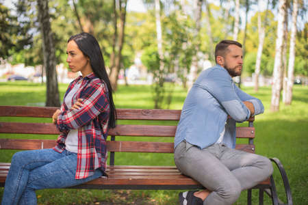 Misunderstanding in couple. Man and woman Resentment. Relationship crisis. Beautiful couple is breaking up in park.の写真素材