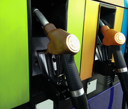 Gasoline pump nozzles at petrol stationの写真素材