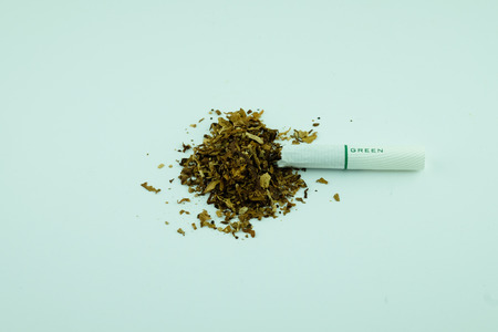 Cigarette and tobacco on a white background.の写真素材