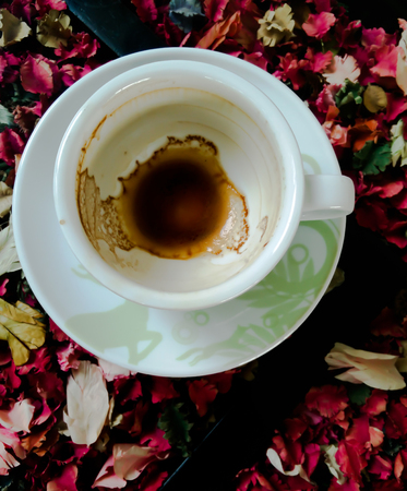 Coffee cup and coffee beans on wooden backgroundの写真素材