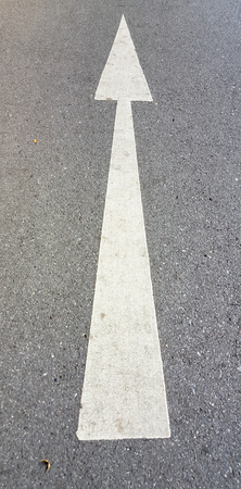 Road, with white arrow signの写真素材