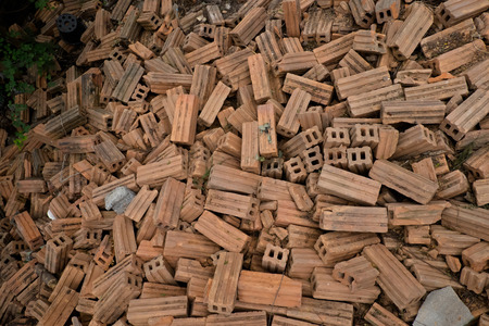 Heap of red brick used backgroundの写真素材