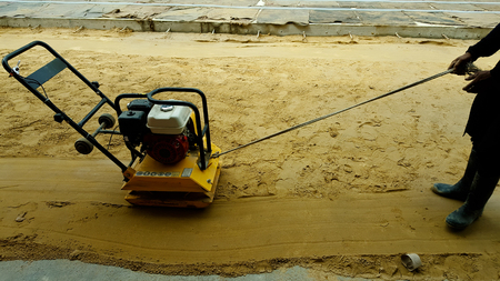 Vibratory plate compactor under construction