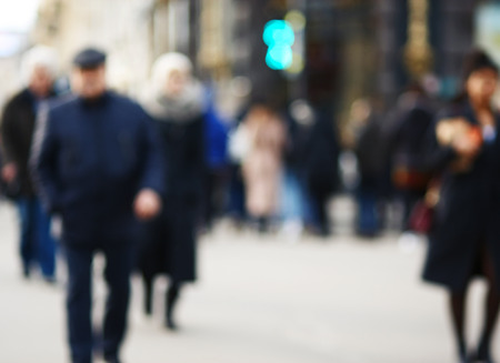 Blurred background where a crowd of ordinary people cross the road in the morning at a city intersection in rush hourの写真素材