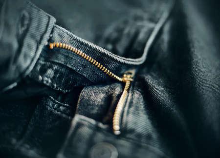 Gray trendy fashionable jeans lie unbuttoned. Zipper on the pants. Casual comfortable clothes.の写真素材