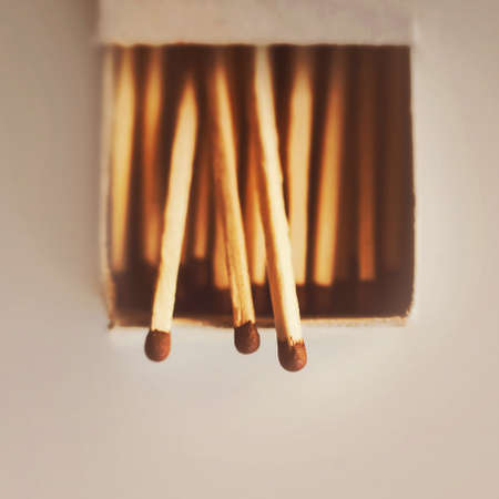 In a simple open cardboard matchbox there are wooden matches with brown sulfur heads. Flammable items. Household items.の写真素材