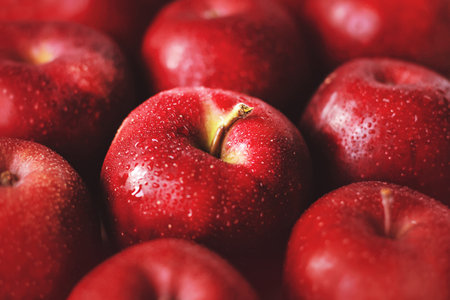 Large red ripe delicious apples in the grocery store. fruit harvest. Proper nutrition. Vegetarian diet.の写真素材