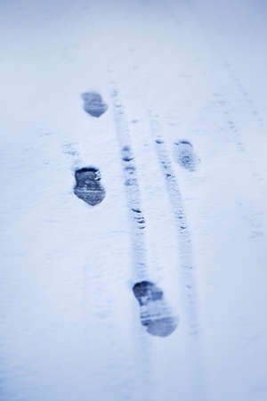 Footprints of a man who walked alone on a January day are left on the white soft snow. Winter.の写真素材