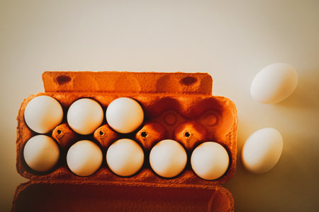 Top view of an orange cardboard box from the store, which contains white chicken eggs. protein breakfast. Health nutrition.の写真素材