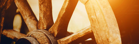 A large wooden wheel of an old rural horse cart. agriculture and ancient transport. harvesting.の写真素材