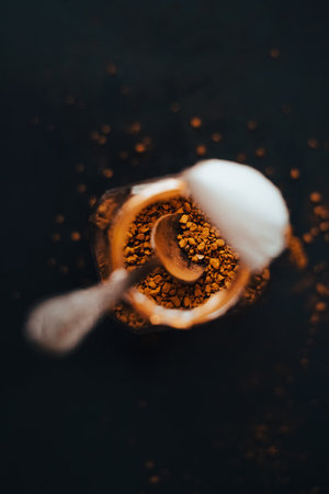 There is a teaspoon in an open jar of instant coffee.の写真素材