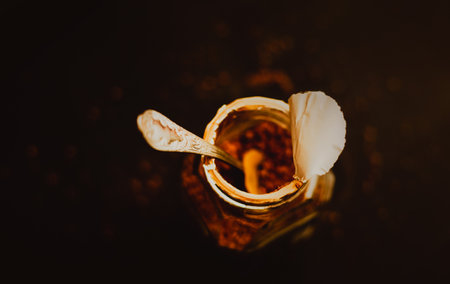 Top view of a jar of strong instant coffee with a silver spoon standing on a dark background, for breakfast. Love for coffee in the morning.の写真素材