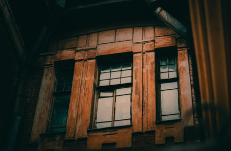 The facade of the old historic building is brown, with tall windows and a drainpipe, reminiscent of imperial buildings.の写真素材