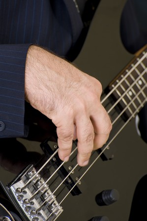 A young male musician playing an electric guitar.