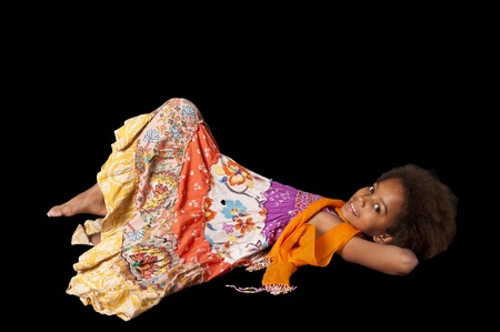A gorgeous little 7yr old African girl in the studio. Black background.の写真素材
