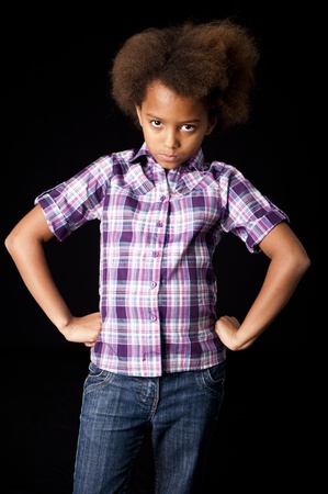 A gorgeous little 7yr old African girl in the studio. Black background.の写真素材