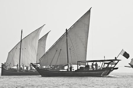 Desaturated image of Arabian dhows, performing during the Qatar National Day festivities in Doha..