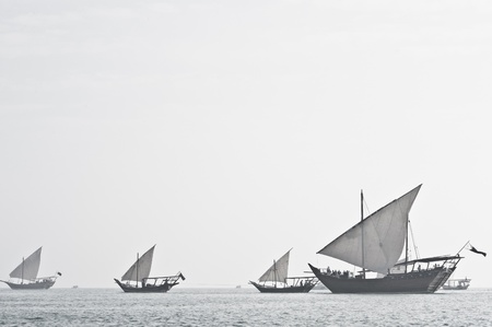 Desaturated image of Arabian dhows, performing during the Qatar National Day festivities in Doha..