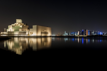 Night shot of the Museum of Islamic Art with reflection and the Doha skyline in the background のeditorial素材