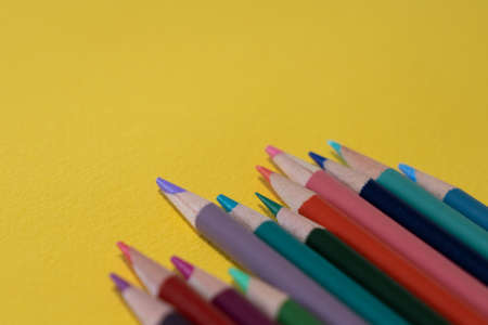 Used color pencils on a yellow backgroundの写真素材