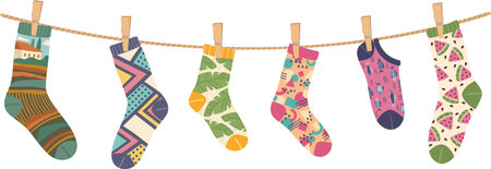 Colorful socks featuring a variety of playful patterns and designs are hanging on a clothesline, infusing the scene with whimsy and a sense of individualityのイラスト素材