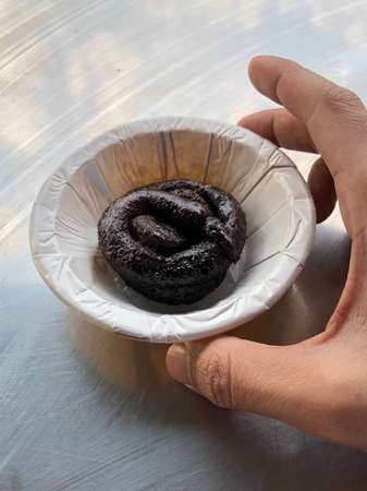 Strange looking dessert, the Black Jalebi served in a paper bowl in Bhopal, Indiaの写真素材