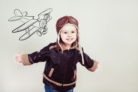 Happy kid against drawn airdrome and skies. Profession collection.の写真素材