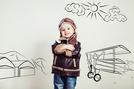 Happy kid against drawn airdrome and skies. Profession collection.の写真素材