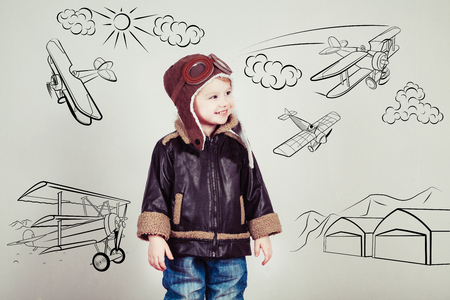Happy kid against drawn airdrome and skies. Profession collection.の写真素材