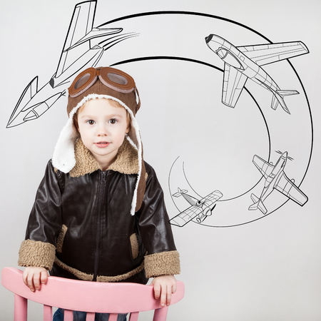 Happy kid against drawn airdrome and skies. Profession collection.の写真素材