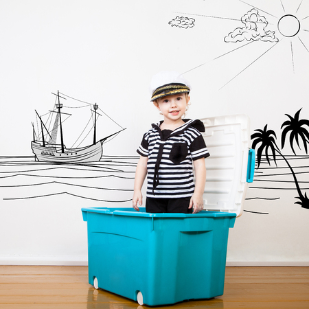 Kid sailor with drawn sea, skies, palms and ship. Profession collectionの写真素材