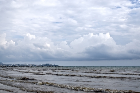 The noisy, dirty sea and dark clouds hanging over itの写真素材