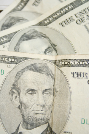 Five dollar bills close-up in disorder