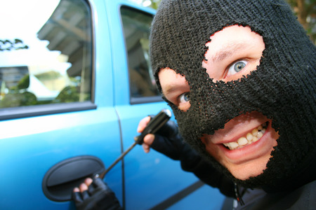 Big bad burglar is smiling at you evil couse he is stealing your carの写真素材
