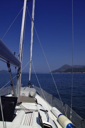 On the deck of sailing boat during sailing over nice blue seaの写真素材