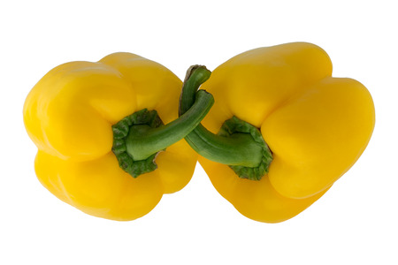 Two yellow bell peppers isolated on white backgroundの写真素材