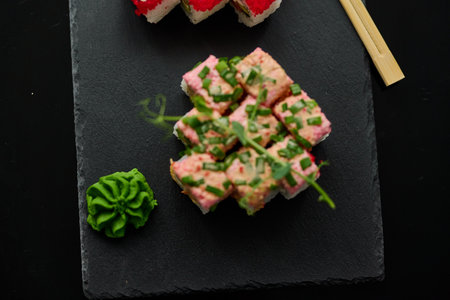Sushi roll with tuna, cucumber, avocado, cream cheese and sesame seeds.の写真素材