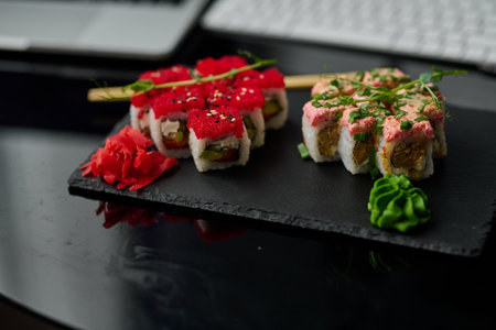Sushi rolls on a black plateの写真素材