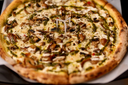 Pizza with mushrooms and mozzarella cheese on a black backgroundの写真素材