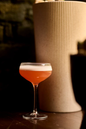 Cocktail in a tall glass on a bar counter in a restaurantの写真素材