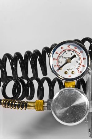 Compressor pressure gauge with black pipes on white background.の写真素材